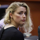 Actress Amber Heard solemnly stares at the camera while in court.